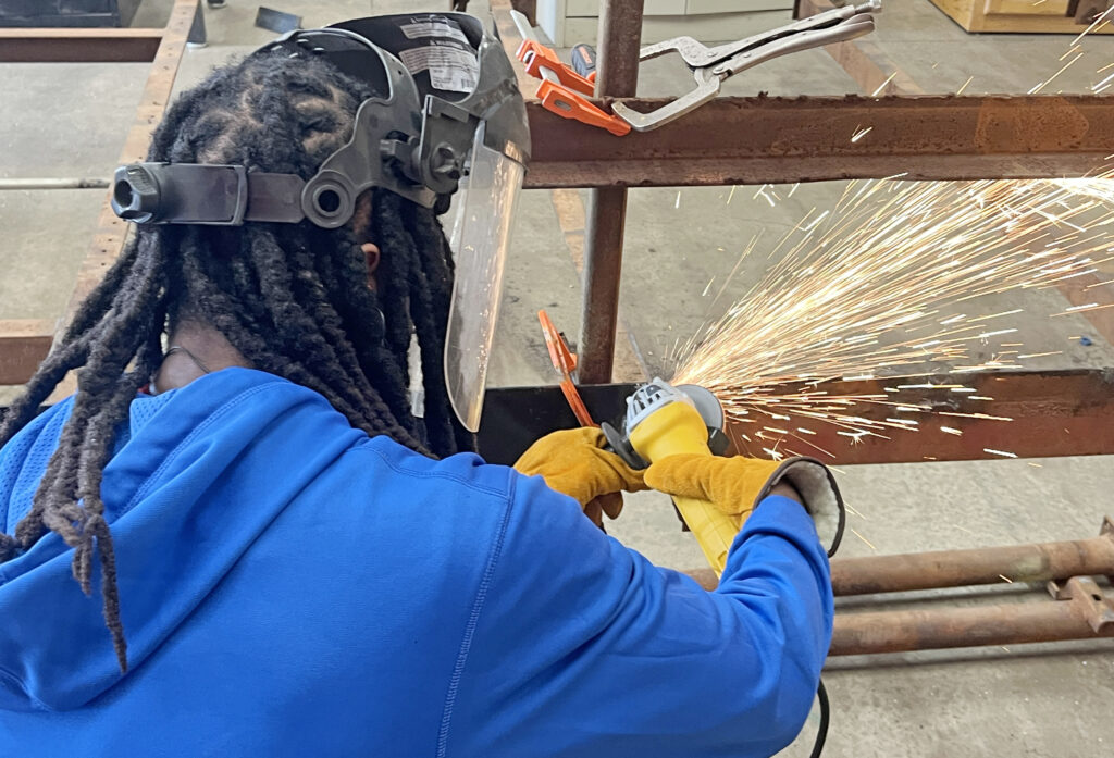 automotive student working with angle grinder