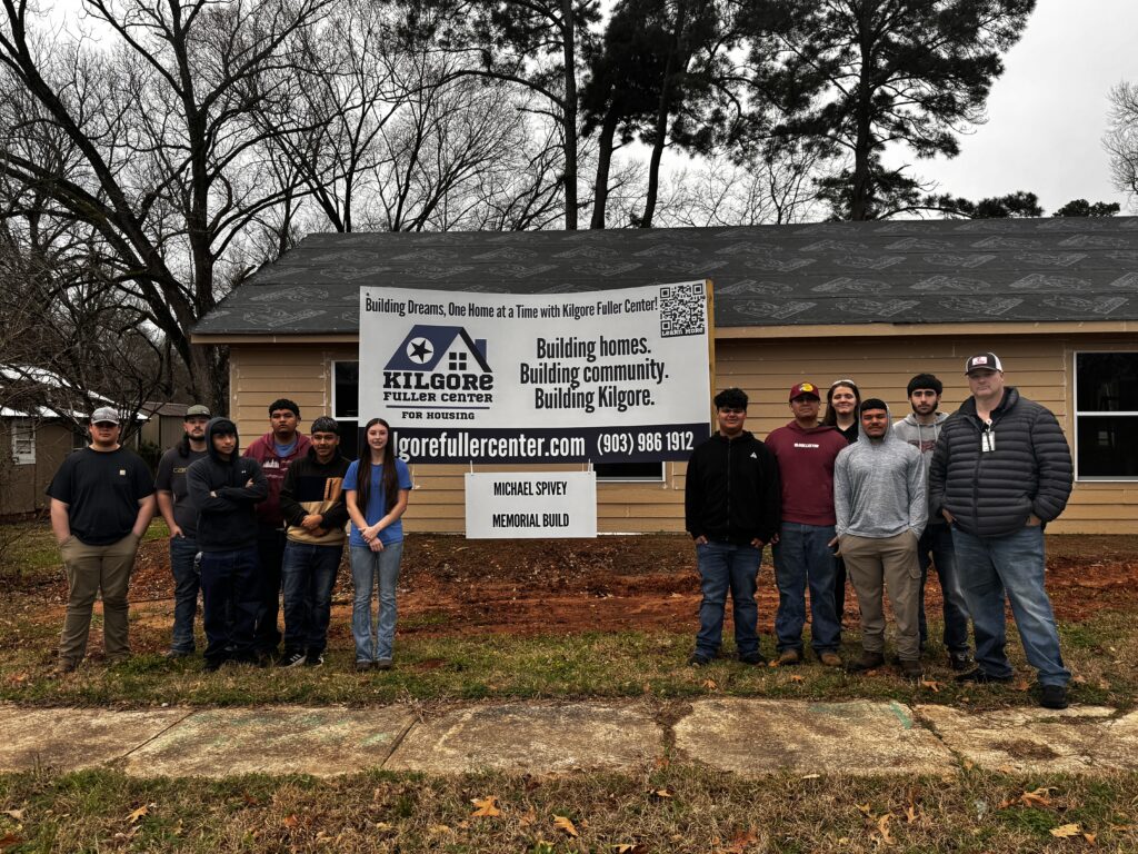 group photo in front of housing project